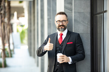 Bearded hipster businessman holding coffee cup portraits.