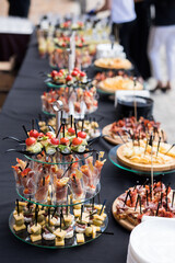 A set of canapes and snack at a banquet with black table