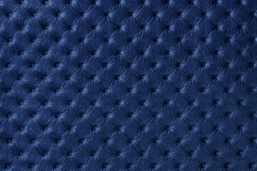 Texture of navy blue leather background with capitone pattern, macro.
