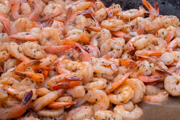 Process of cooking fresh red king prawns on grill at summer local food market - close up view. Outdoor cooking, gastronomy, seafood, barbecue, street food concept