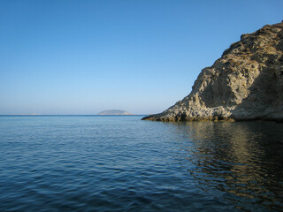 Fototapeta na wymiar Calm sea and a rock reflection
