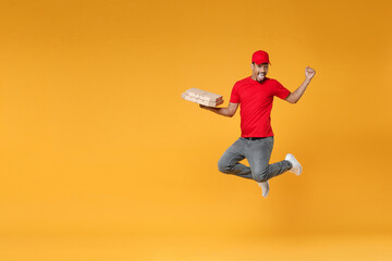 Fototapeta na wymiar Full length delivery employee african man in red cap blank print t-shirt uniform work courier service concept hold give food order pizza cardboard boxes jump run isolated on yellow background studio.