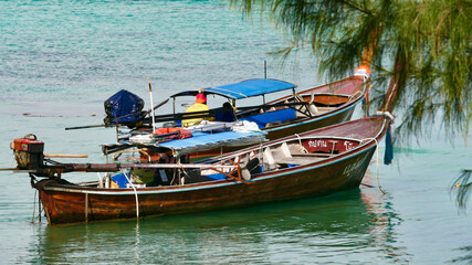 Naklejka na ściany i meble Ko Lipe, Satun, Thailand : November-9-2020 : Traditional wooden long tail boats parking at Lipe Island, Satun, Thailand.