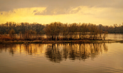 Island on the river in winter. Cold sunrise