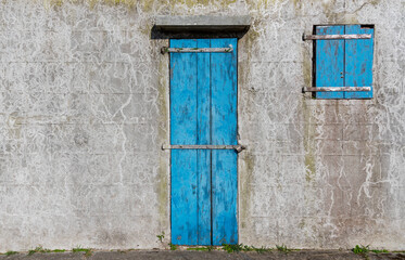 Blue locked door and window of grunge building