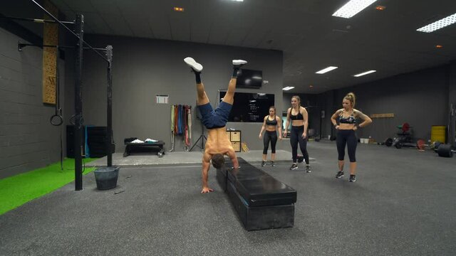 Adaptive athlete doing handstand while exercising at gym