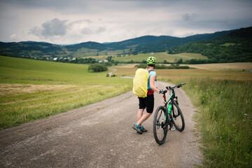 Obraz premium Young woman with helmet riding a bicycle. Enjoying sport in nature. 