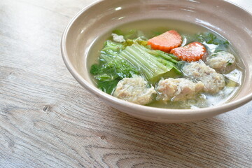 boiled cabbage and carrot with chop pork stuffed glass noodles soup on bowl