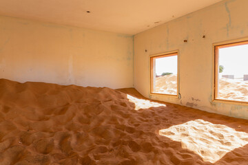 Neglected house interior buried in sand in village Al Madam in United Arab Emirates.