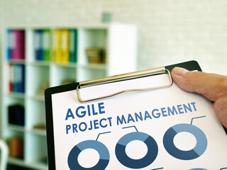 Man reads Agile Project Management information in the book. © Vitalii Vodolazskyi