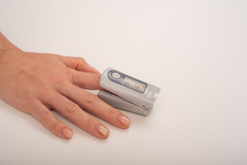 Female hand with a measuring device saturation. Blood oxygen level in coronavirus