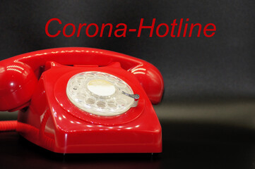 Rotes Telefon mit Schriftzug Corona Hotline