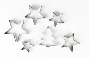 Metal forms for cookies in the form of a star and a Christmas tree on a white background.
