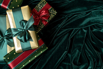 Gift boxes wrapped in gold paper with tidewater green satin ribbons. Happy New Year.