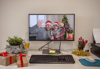 Portrait of happy couple celebrating christmas online cheering and showing presents. Webcam view