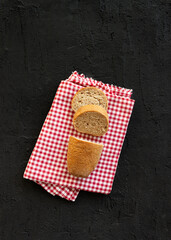 Sliced bread isolated on textured dark black background. Healthy bread. Ketogenic diet.