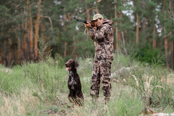 Man Aiming with Rifle Hunt in Summer Forest.