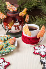 White Cup of tea in a red scarf with homemade butterfly cookies and a Christmas lantern. Close-up, copy space