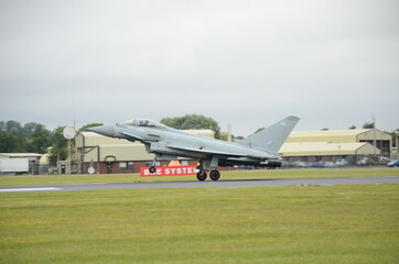 fighter jet landing on military airfield 