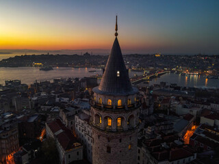 Fototapeta premium Aerial Galata Tower at Sunset. Galata Bridge and Golden Horn of Istanbul with beautiful colors at Sunset. 