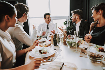 A men with a birthday boy sits at a table.