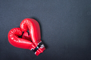 Gym background and fitness equipment and valentine concept. Boxing glove in shape of heart.