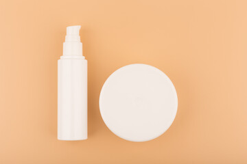 Flat lay with face and body cream on a beige background. Minimalistic concept of beauty and skin care