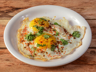 Indian style tasty and healthy double egg half fried omelet on a wooden rustic background. selective focus