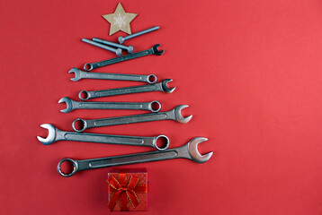 Christmas tree made of various tools with a red gift box. Happy christmas and happy new year