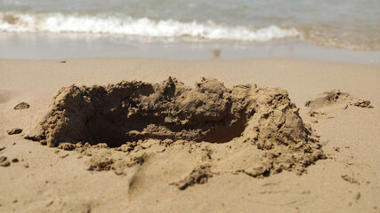 destructive wave castle on the sand by the sea