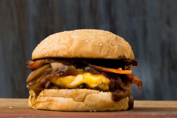 Delicious Cheddar Cheese Burger with Caramelized Onions and Bacon