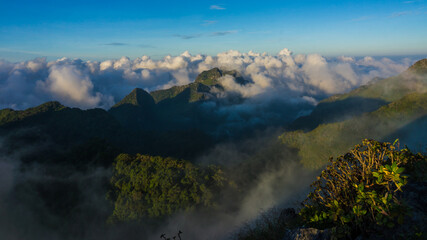 Morning sunrise with fog on top of mountain blue sky vacation trekking winter