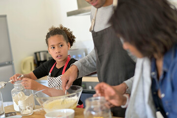 Happy family in home kitchen making homestyle american cookies