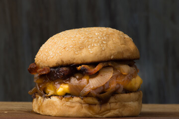 Delicious Cheddar Cheese Burger with Caramelized Onions and Bacon