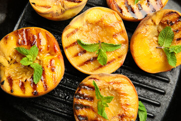 Delicious grilled peaches with mint in pan, flat lay