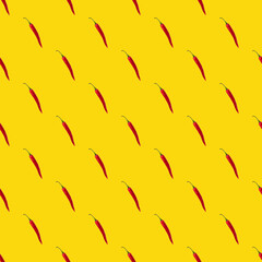 Seamless pattern made of isolated red chili peppers on yellow background. Top view. Food flatlay.