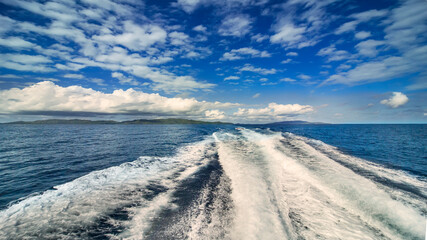 Seascape, white trace of a passing boat on the turquoise water.