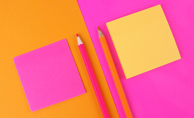 Pink and yellow paper for writing with pencils. Bright orange and pink background