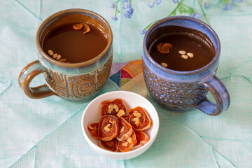 Dessert Korean punch with persimmon, cinnamon, and ginger which is called Sujeonggwa