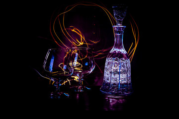 Glass luxury bottle with light painting and old style of drinking a fresh drink