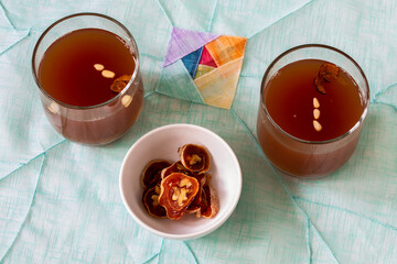 Dessert Korean punch with persimmon, cinnamon, and ginger which is called Sujeonggwa