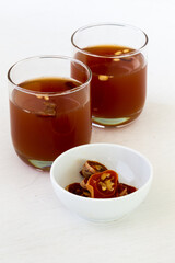 Dessert Korean punch with persimmon, cinnamon, and ginger which is called Sujeonggwa