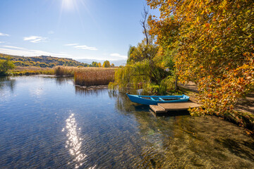 Wooden boat at pier on beautiful lake