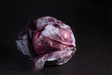 Red cabbage isolated on black background, closeup