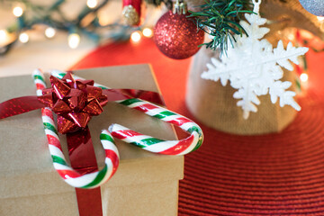 Christmas tree decorations on table. Christmas and New Year preparation concept. Christmas tree with gift box and candies in heart shape.