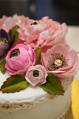 White cake with pink flowers on golden tray