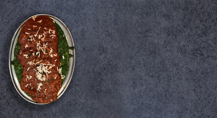 Vegetarian chilli milli and spicy masala gravy. Top view on a dark wood banner background with copy space.