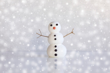Cute snowman figure on winter frozen background with snowflakes. Mockup, artificial scene, greeting...