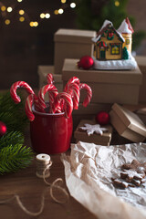 Christmas composition. Little house, sweet canes, gingerbread and gifts. Christmas light