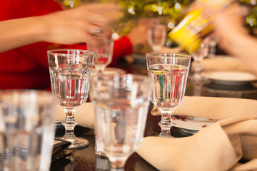 Glass of water set on the Christmas dinner with family.